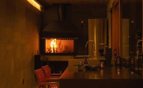 a kitchen with a fire in a fireplace at THE W Relax Garden Resort - Vacation STAY 09071v in Yoshioka