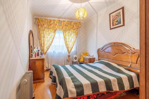 a bedroom with a bed and a window at Amorosa house in Viana do Castelo