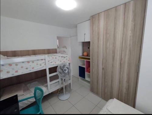 a small room with a bunk bed and a fan at Casa Lagos do Frances in Marechal Deodoro