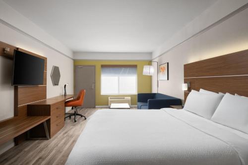 a hotel room with a large bed and a television at Holiday Inn Express Hotel & Suites San Dimas by IHG in San Dimas