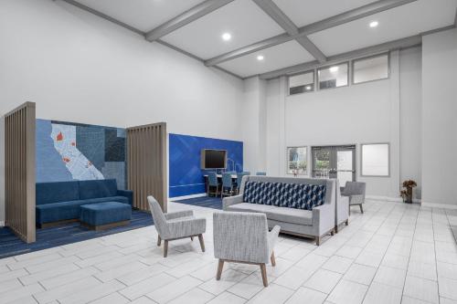 a living room with a couch and chairs and a tv at Holiday Inn Express Hotel & Suites San Dimas by IHG in San Dimas