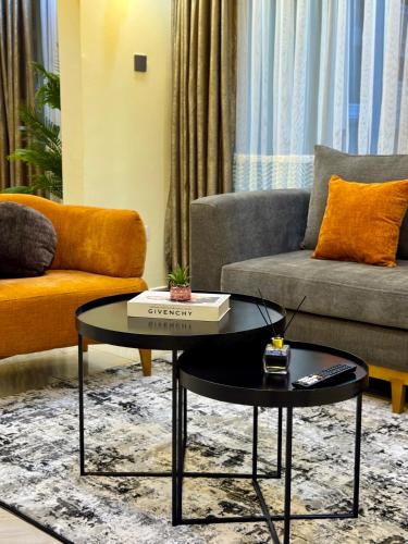 a living room with a coffee table and a couch at Lipsy Homes Kungu in Kampala
