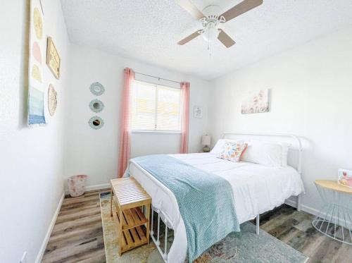 a bedroom with a bed and a ceiling fan at Lovely Home Central Coalinga in Coalinga