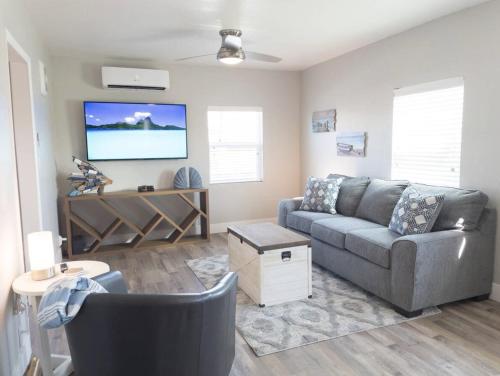 a living room with a couch and a flat screen tv at Ocean Breeze Harrison Ranch 2 in Visalia