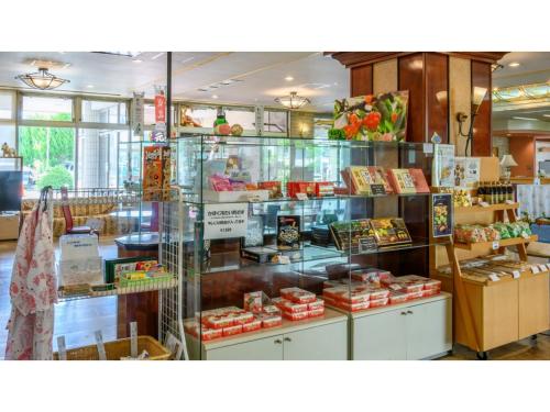 a display case in a store filled with lots of food at Hotel Symphony - Vacation STAY 85393v in Sagae