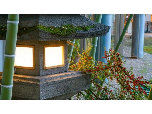 a stone bird house with two lights on it at Hotel Symphony - Vacation STAY 85392v in Sagae