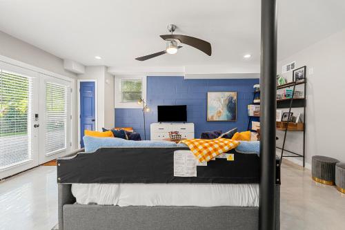 a bedroom with two beds and a blue wall at The Rhitreat, Studio, 10 Min Downtown & Airport in Atlanta