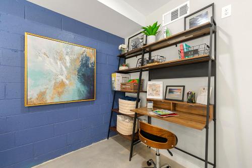 a room with a desk and a blue wall at The Rhitreat, Studio, 10 Min Downtown & Airport in Atlanta