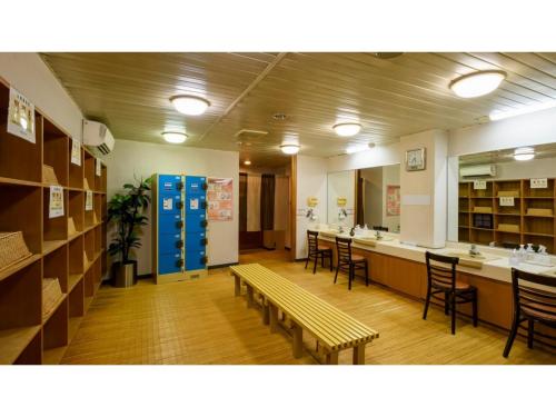 a library with chairs and a table and a bench at Hotel Symphony - Vacation STAY 85392v in Sagae