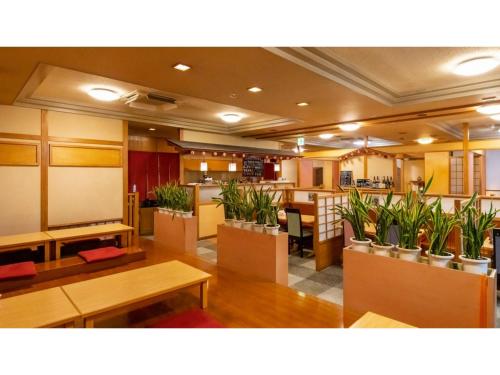 a restaurant with potted plants in the middle of a room at Hotel Symphony - Vacation STAY 85394v in Sagae