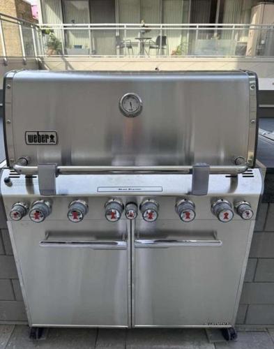 a large stainless steel grill sitting on a sidewalk at High Rise 2BR Contemporary Condo w City Views next to Eaton Centre in Toronto