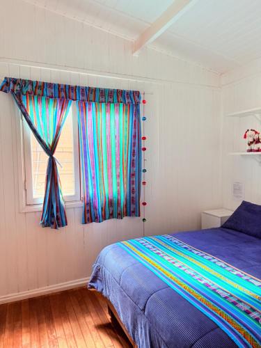 a bedroom with a bed and a window at MAKTVB - EcoLodge San Pedro de Atacama in San Pedro de Atacama