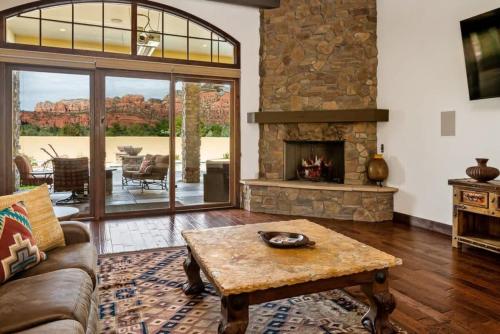 a living room with a couch and a fireplace at Enchanting Sedona Villa with Views Spa and Pool in Sedona