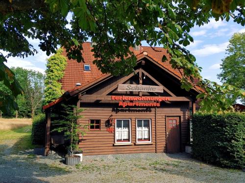 a small wooden building with a sign on it at FerienFleckl in Warmensteinach