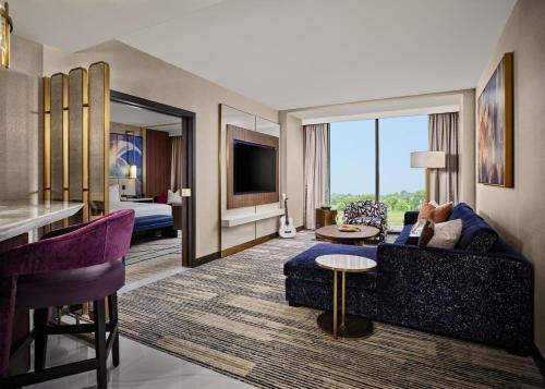 a hotel room with a couch and a living room at Hard Rock Hotel & Casino Ottawa in Ottawa