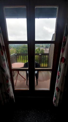 a window with three views of a balcony at FerienFleckl in Warmensteinach