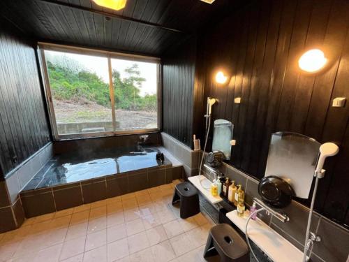 a bathroom with a tub and a large window at Peace Inn Hagi - Vacation STAY 92109v in Hagi