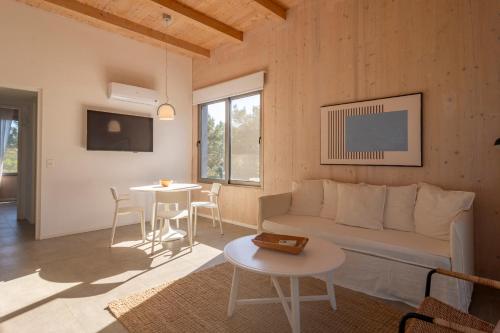 a living room with a couch and a table at Anastasio Hotel & Beach Club in José Ignacio