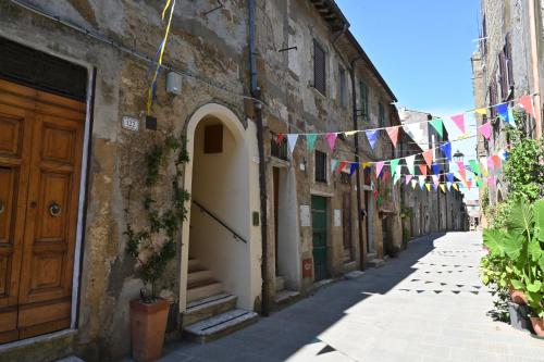 an alley with flags and bunting in an old building at il Cantuccio in Pitigliano
