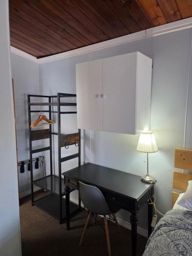 a bedroom with a desk and a bunk bed at Bio Vista Motel in Wainwright