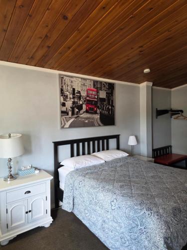 a bedroom with a bed and a picture of a fire truck at Bio Vista Motel in Wainwright