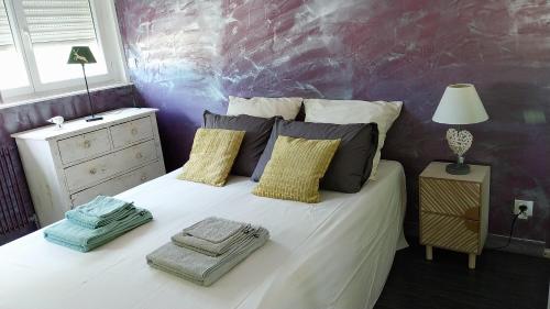 a bedroom with a large white bed with pillows at Superbe appartement avec piscine et parking in Fréjus