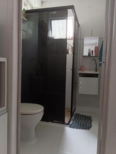 a bathroom with a shower with a toilet and a sink at Hospedagem Nininha in Ananindeua