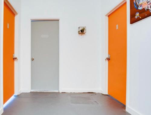 an empty hallway with orange doors in a building at The Miami Hostel - Free Dinner - Women Rooms -Men Rooms -Fast Wi-Fi - Free Coffee - 24hr check in Available in Miami