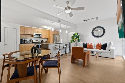 a living room and kitchen with a table and a couch at Amethyst Horizon - Stylish peaceful 2BR w zen Garden View Pool Gym in Los Angeles