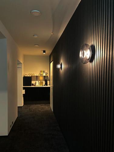 a hallway with two lights on a wall at Amma Jóna rooms in Ásólfsskáli