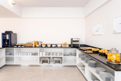 a kitchen with a counter with food on it at Fueguino Hotel in Ushuaia