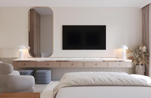 a bedroom with a tv on a wall at StOliva RESIDENCES Bay pearl 