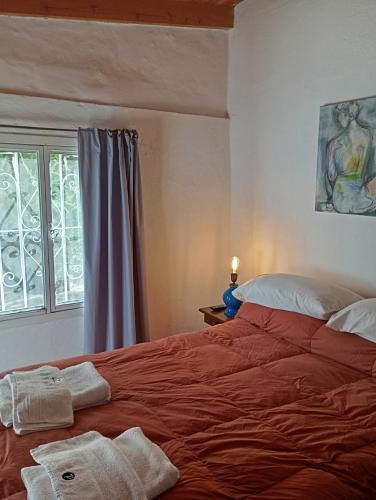 a bedroom with a large red bed with a window at Posada de Nono in Nono