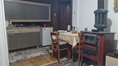 a kitchen with a table and a stove in it at Seoski dom in Šavnik