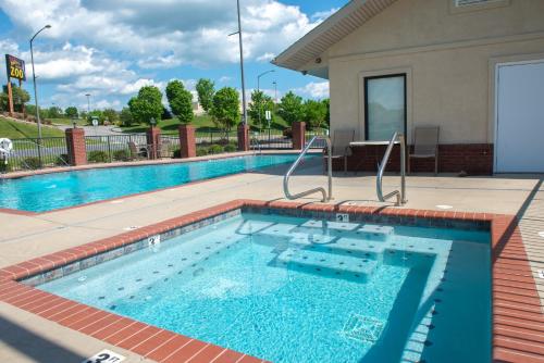 a large swimming pool with a tile floor and a building at River Crossing Condominiums - A Beautiful River View in Pigeon Forge