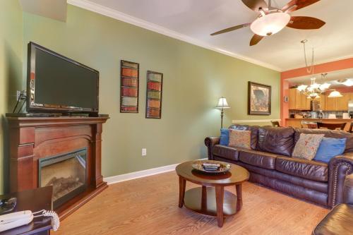 a living room with a couch and a fireplace at River Crossing Condominiums - A Beautiful River View in Pigeon Forge