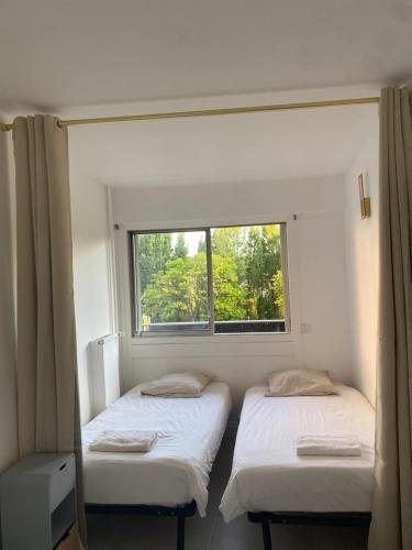 Ένα ή περισσότερα κρεβάτια σε δωμάτιο στο Appartement les Remylis
