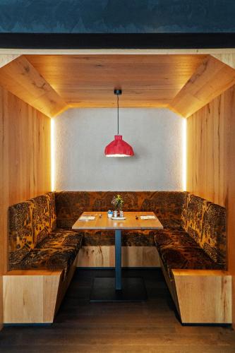 a dining room with a table and a red light at La Tambra - Hotel Lodge in Santa Cristina in Val Gardena