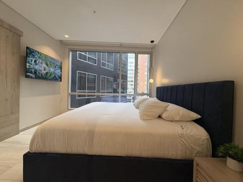 a bedroom with a large bed with a large window at Le Parc Hotel, Beyond Stars in Quito