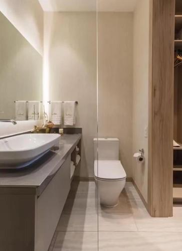 a bathroom with a white toilet and a sink at Le Parc Hotel, Beyond Stars in Quito