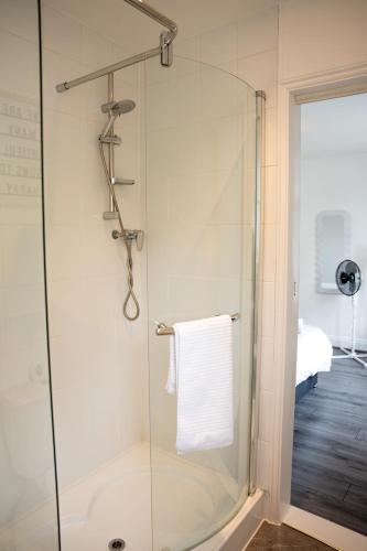 a shower with a glass door in a bathroom at Modern 3 Bed Bromley, Chislehurst House - with parking in Chislehurst