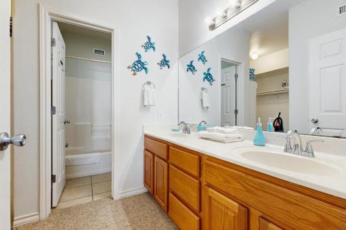 a bathroom with a sink and a toilet and a mirror at Compass Condominiums B8 in Corpus Christi