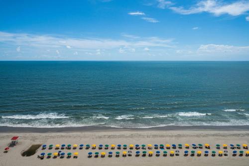 a view of the beach with umbrellas and the ocean at Courtyard by Marriott Myrtle Beach Oceanfront in Myrtle Beach