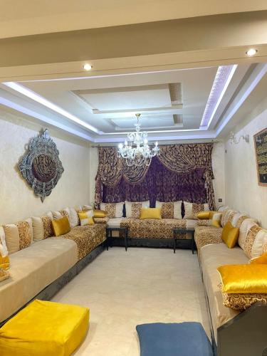 a large living room with couches and a chandelier at Diamond Residence Fes in Fez