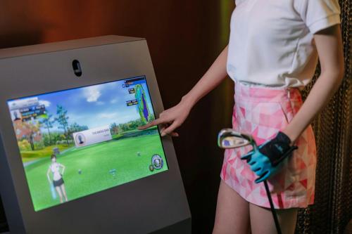 a woman is playing a video game on a wii at Chiang Mai Marriott Hotel in Chiang Mai