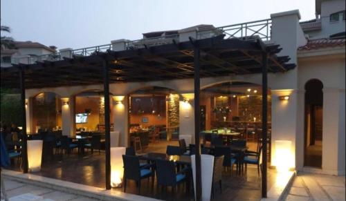 a restaurant with tables and chairs on a patio at La vista 5 ain sokhna Luxury sea view عين سخنة لا فيستا in Ain Sokhna