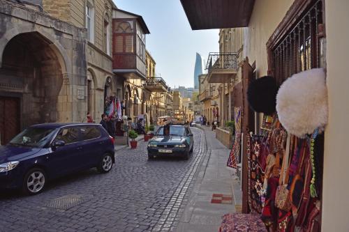 a cobblestone street with cars parked on the street at CaffaSoffia in Baku