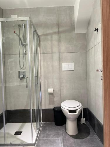 a bathroom with a toilet and a glass shower at Hotel Brivio in Milan