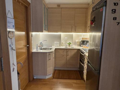 a small kitchen with a sink and a refrigerator at Centrica Suite de Lujo Parking Incluido in Vigo