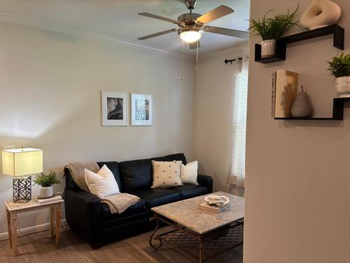 a living room with a black couch and a table at The perfect place in Spring